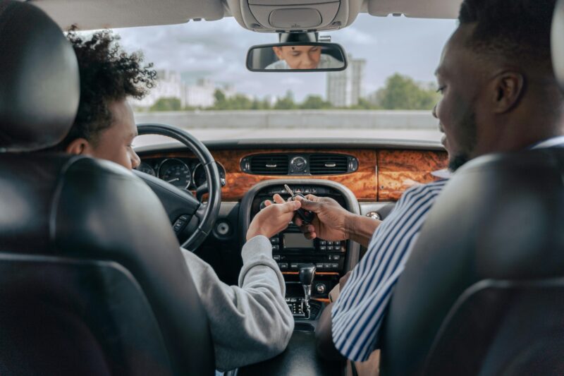Driving instructor with pupil in dual control car